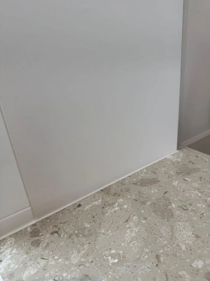 Paneel en plint afgewerkt tegen een terrazzovloer
